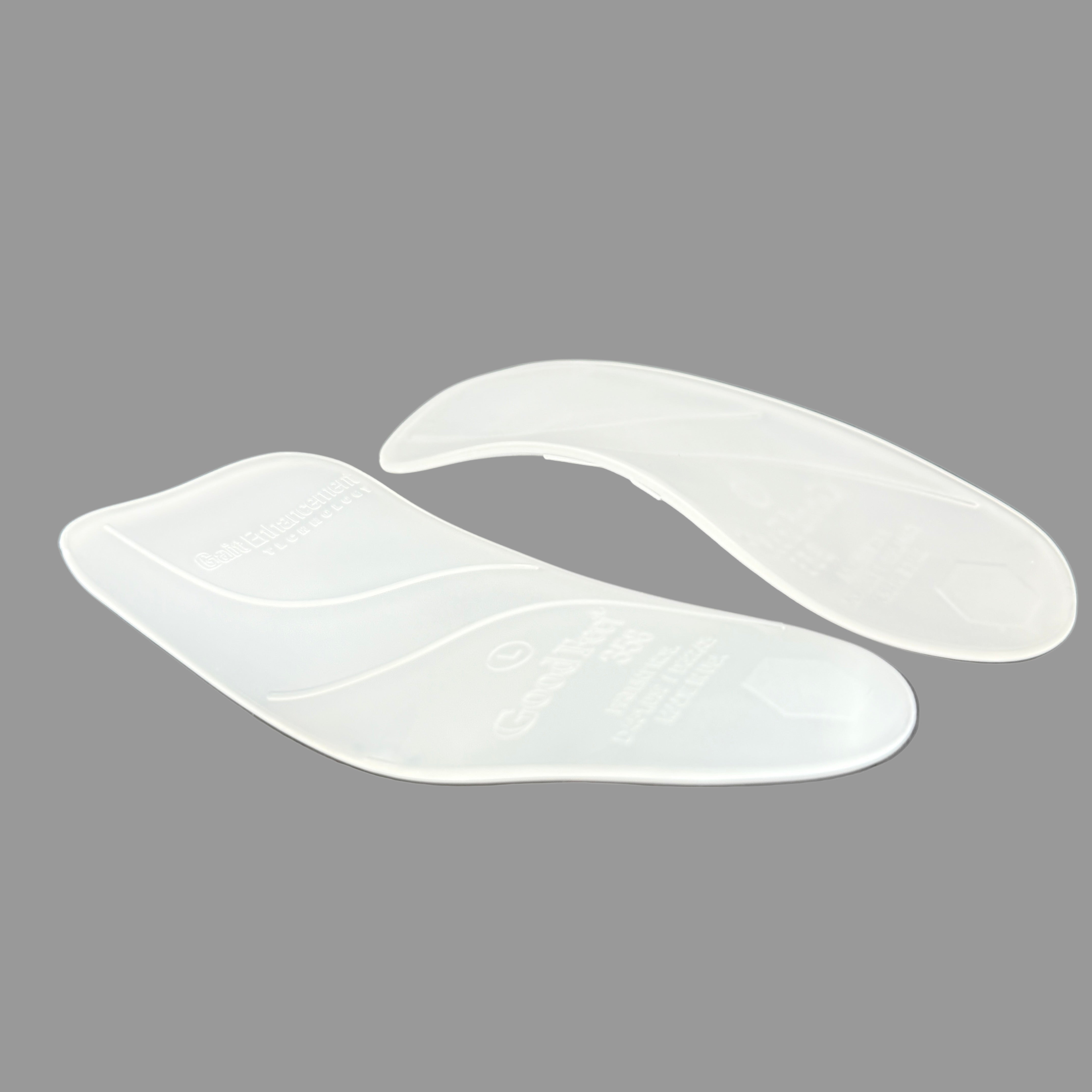 Pair of white shoe insoles on a gray background